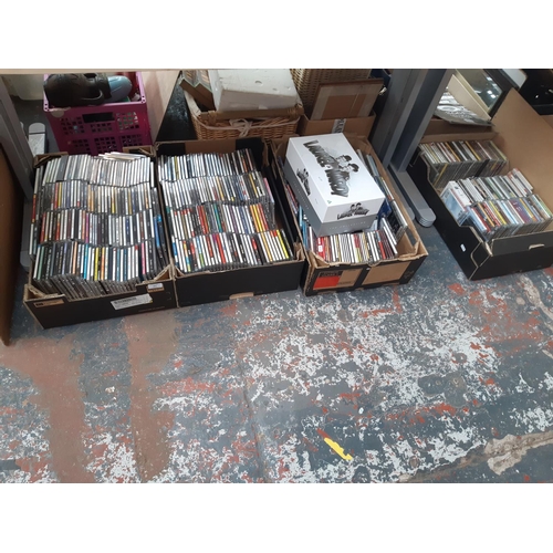 363 - Four boxes containing various CDs and a Laurel & Hardy complete collection DVD box set