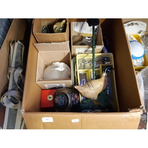 410 - Three boxes containing mixed items to include cast iron mallard duck door stop, cutlery, glassware, ... 