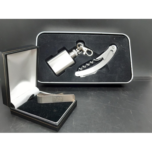 60 - Two items to include a hallmarked 925 silver money clip and a miniature hip flask and bottle opener/... 