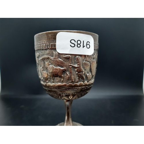 7 - A middle eastern white metal two section goblet with  repousse farming and village scenes - measurin... 