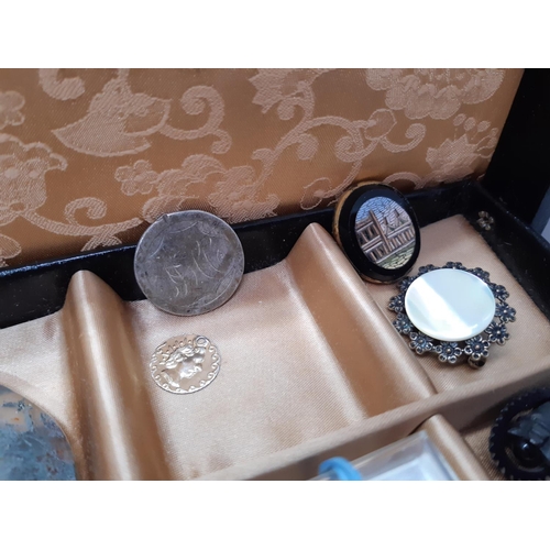 72a - A black jewellery box containing a collection of vintage costume jewellery to include Whitby jet sty... 