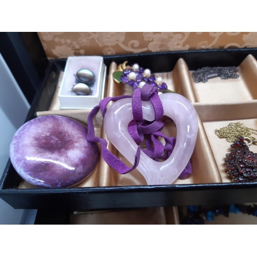 72a - A black jewellery box containing a collection of vintage costume jewellery to include Whitby jet sty... 