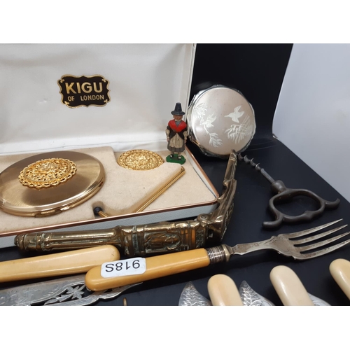 73 - A box containing various items to include vintage brass nutcracker, pewter corkscrew, men's wristwat... 