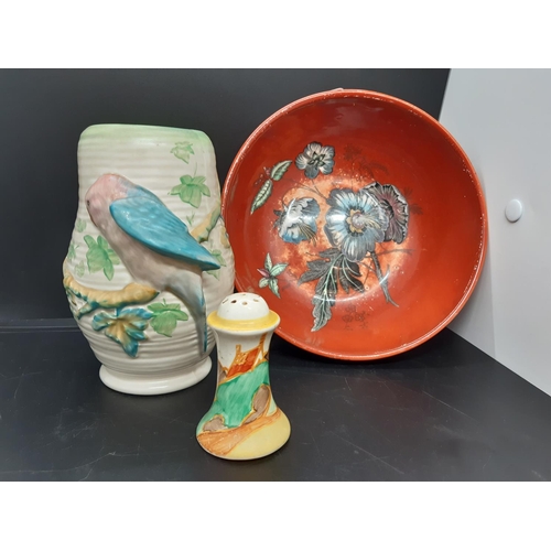 128 - Three pieces of Clarice Cliff pottery to include a red floral patterned bowl measuring approx. 19.5c... 