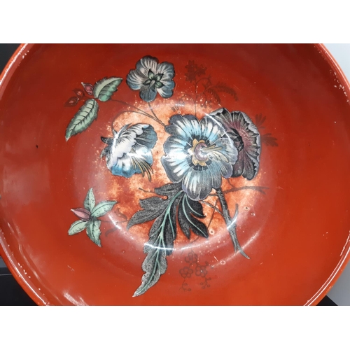 128 - Three pieces of Clarice Cliff pottery to include a red floral patterned bowl measuring approx. 19.5c... 