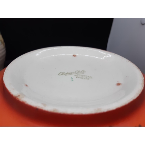 128 - Three pieces of Clarice Cliff pottery to include a red floral patterned bowl measuring approx. 19.5c... 