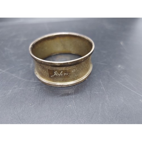 19A - Three napkin rings to include two hallmarked Birmingham silver napkin rings and a trench art napkin ... 