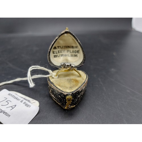 75A - A cased hallmarked 18ct gold ladies ring with three inset diamonds - size P and approx. total weight... 