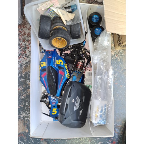 411 - A boxed Subaru Impreza remote control rally car and two boxes containing Commando magazines