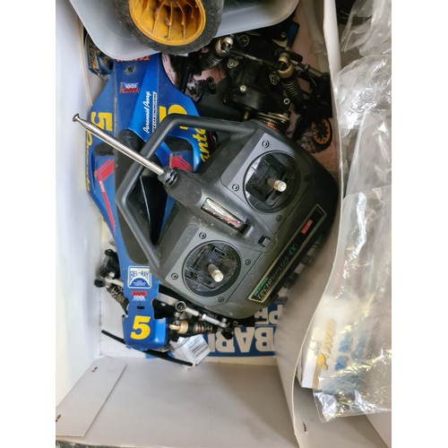 411 - A boxed Subaru Impreza remote control rally car and two boxes containing Commando magazines