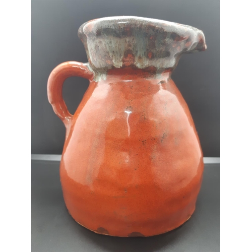 82 - Two pieces of mid 20th century studio pottery to include a bulbous clay pot and a drip glazed handle... 