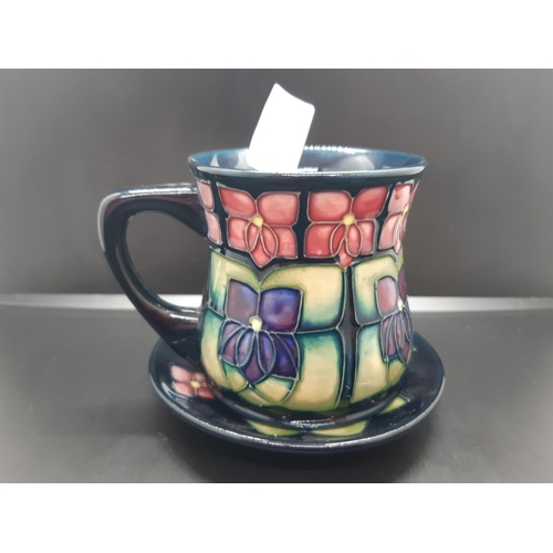 91 - Two pieces of Moorcroft pottery in the Violet pattern to include trinket dish and mug - dish measuri... 