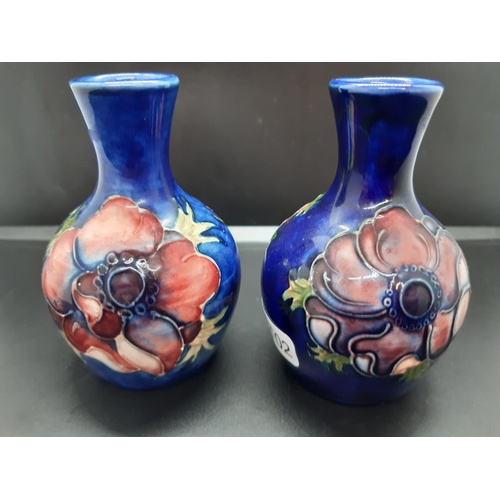 93 - A pair of Moorcroft pottery vases in the Anemone pattern - measuring approx. 9.5cm in height