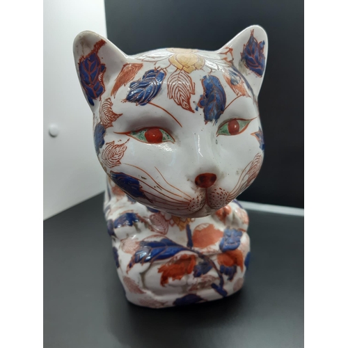 103 - A large Chinese Imari pattern slip cast recumbent cat upon decorated plinth profusely embellished th... 