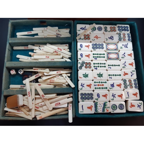 122 - An early 20th century leather cased Chinese Mahjong set with tiles, counters etc. - each tile measur... 