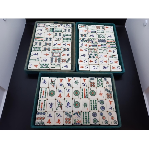 122 - An early 20th century leather cased Chinese Mahjong set with tiles, counters etc. - each tile measur... 