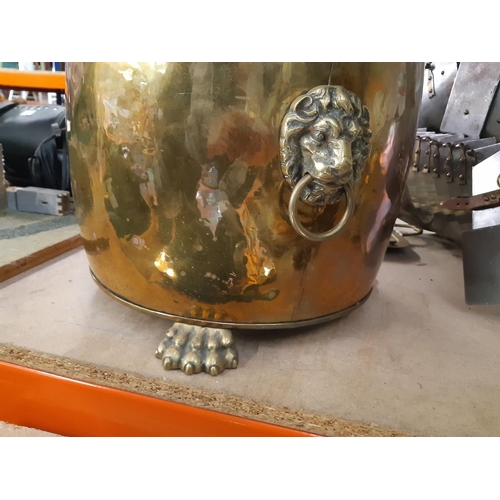 137 - A vintage brass coal bucket with lion paw feet and mask handles - measuring approx. 31.5cm high and ... 