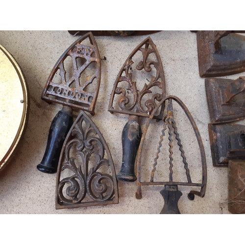 165C - Four 19th century charcoal flat irons and four various flat iron stands