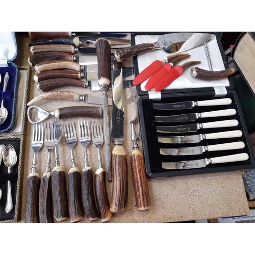 165E - A large collection of cased and loose vintage cutlery to include antler handled cutlery, teaspoons, ... 