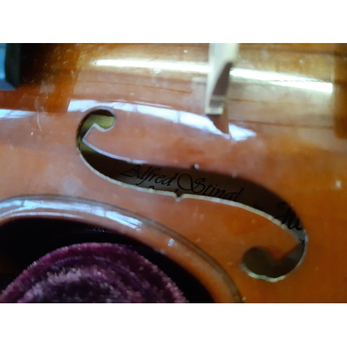 201 - A cased Alfred Stingl by Höfner ⅛ size child's violin with bow and rosin