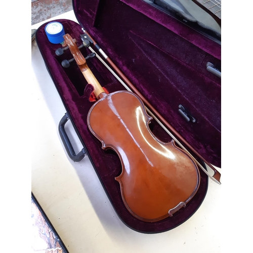 201 - A cased Alfred Stingl by Höfner ⅛ size child's violin with bow and rosin