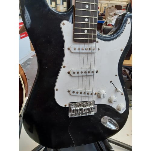 206 - A Power Play black six string electric guitar with carry bag (stand not included and strung left han... 