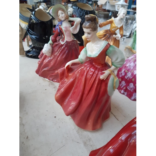 215 - Five Royal Doulton figurines to include 'Top O' The Hill', 'Innocence', 'Gail', 'Fair Lady (Red)' an... 