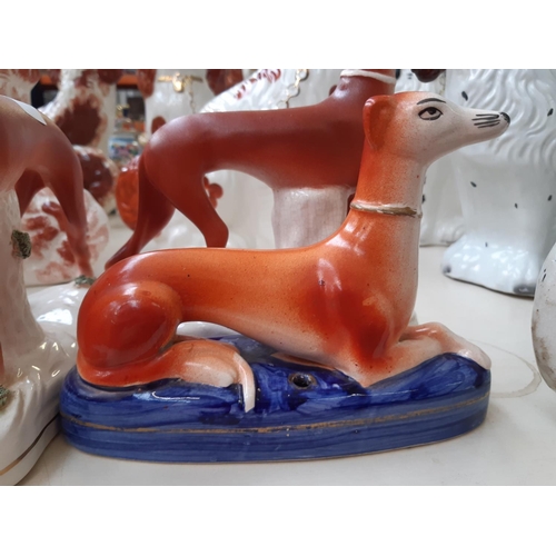 228 - Four 19th century style Staffordshire greyhound figurines to include two inkwells