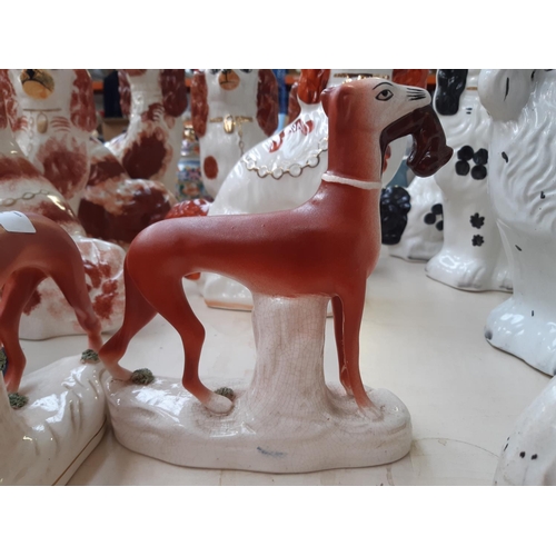 228 - Four 19th century style Staffordshire greyhound figurines to include two inkwells