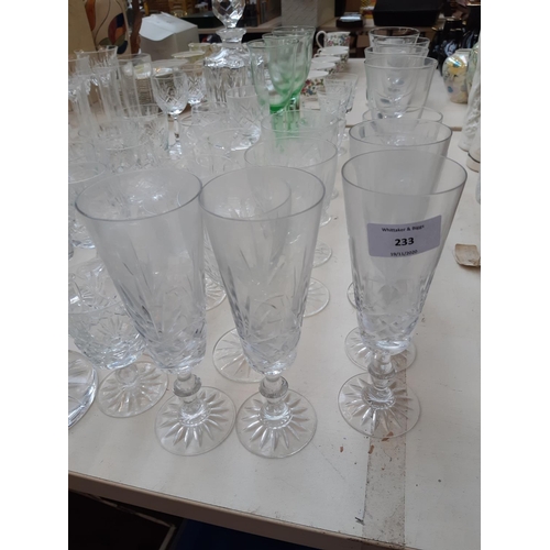 233 - A large collection of various glassware to include cut crystal decanter, champagne flutes, cut cryst... 