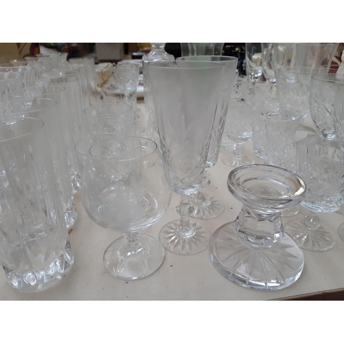 233 - A large collection of various glassware to include cut crystal decanter, champagne flutes, cut cryst... 