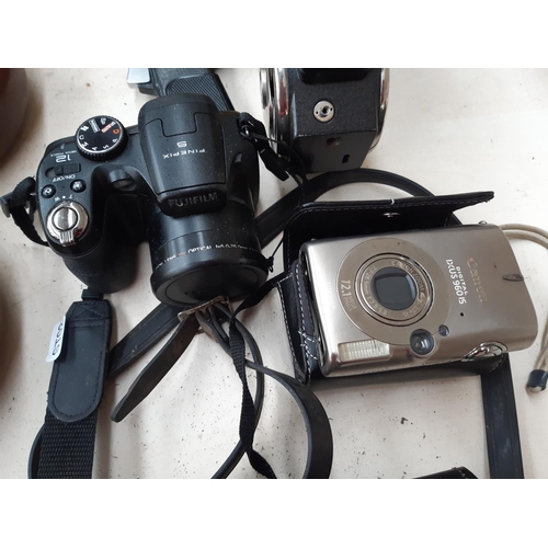 267 - Four items to include a black leather cased Cowley automatic level, Canon IXUS 960 IS 12.1 megapixel... 