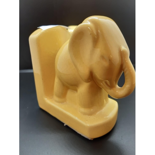 95 - A pair of 1930s style yellow ceramic elephant bookends