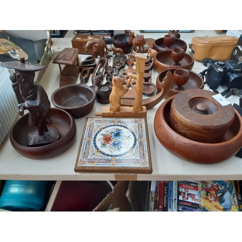 268 - A large collection of treenware to include Burma teak bowls, carved cutlery, figurines, table lamp, ... 