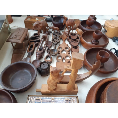 268 - A large collection of treenware to include Burma teak bowls, carved cutlery, figurines, table lamp, ... 