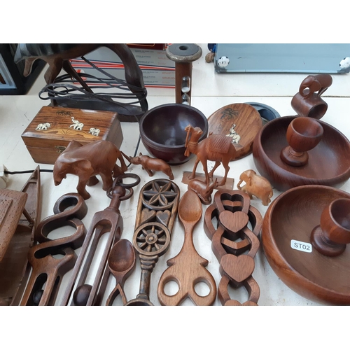 268 - A large collection of treenware to include Burma teak bowls, carved cutlery, figurines, table lamp, ... 