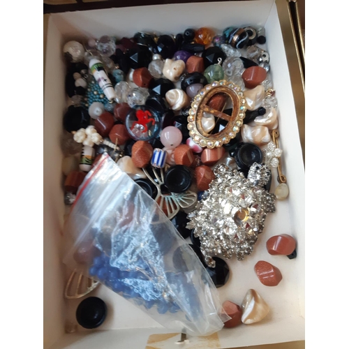 271 - A box containing modern and vintage costume jewellery to include watches, brooches, necklaces etc.