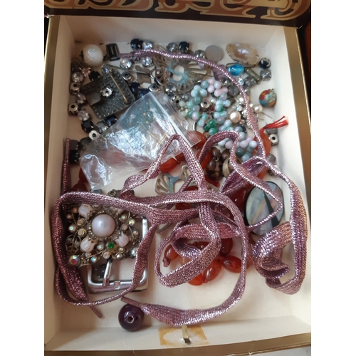 271 - A box containing modern and vintage costume jewellery to include watches, brooches, necklaces etc.