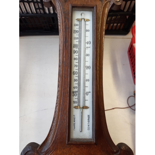 285 - A Victorian carved oak banjo barometer - measuring approx. 91cm high and 28.5cm wide