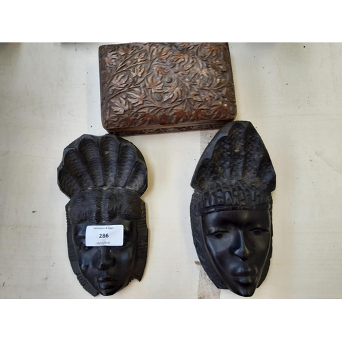 286 - Twelve pieces of assorted treenware to include African tribal style busts, African carved ebony wall... 