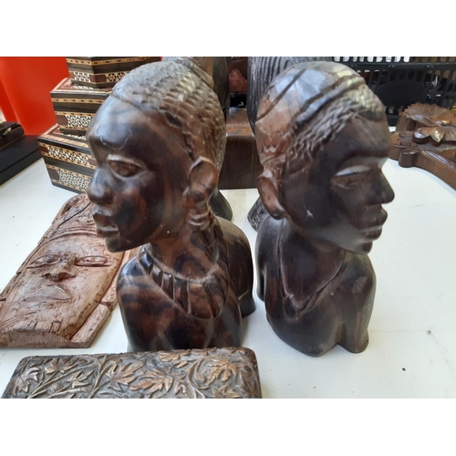 286 - Twelve pieces of assorted treenware to include African tribal style busts, African carved ebony wall... 