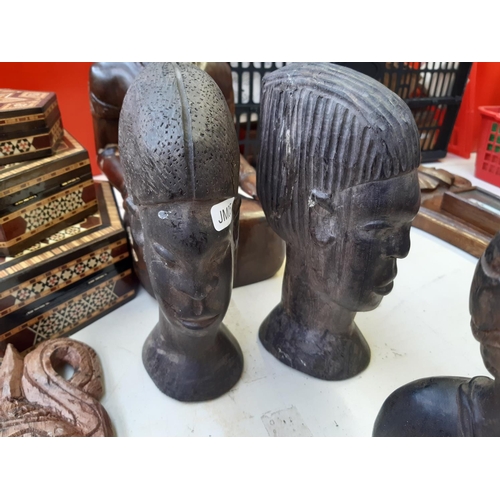 286 - Twelve pieces of assorted treenware to include African tribal style busts, African carved ebony wall... 