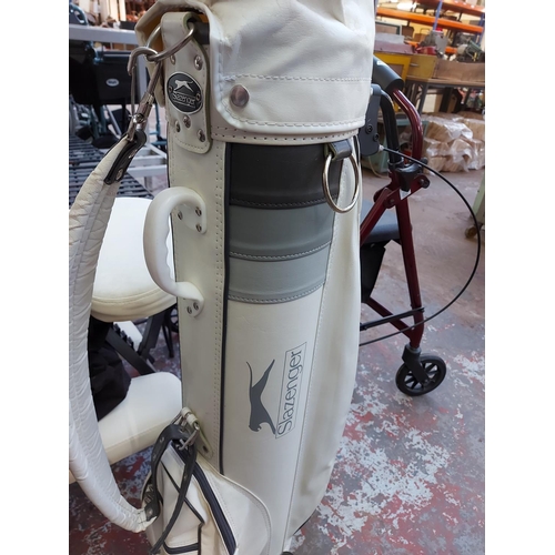 1021 - A white Slazenger golf bag containing Penfold golf clubs