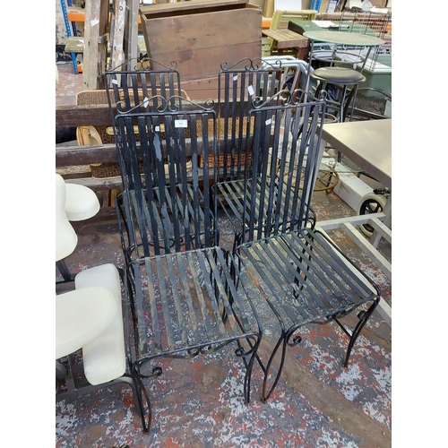 1024 - Four black painted metal garden chairs