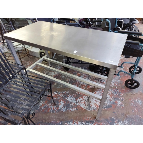 1025 - A stainless steel table measuring approx. 4' X 2' X 33