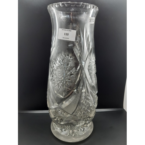 110 - A heavy cut crystal vase - measuring approx. 33cm high