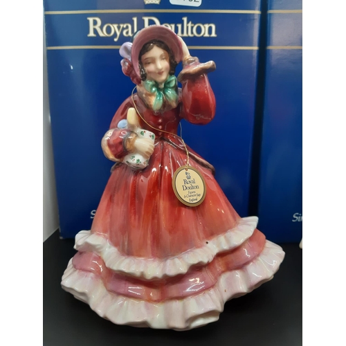 114 - Two boxed Royal Doulton figurines to include 'Christmas Time' and 'Paisley Shawl'