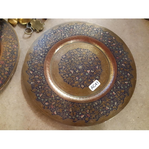 141 - A collection of assorted metalware to include a pair of Middle Eastern brass plates with enamel deco... 