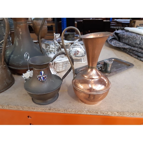 173 - A large collection of assorted metalware to include copper jugs, large brass jam pan, copper kettle,... 