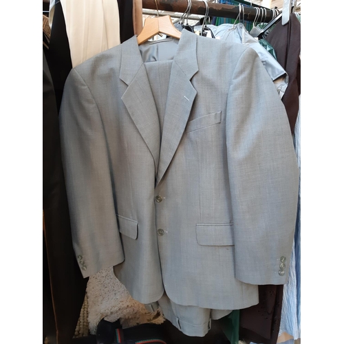 189 - A large quantity of various clothing to include men's suit jackets, as new Farah suit trousers, shir... 